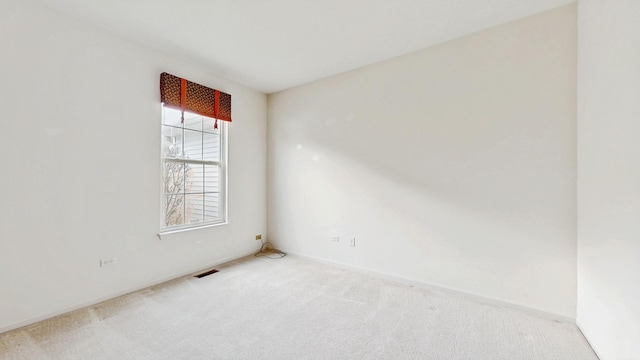 carpeted spare room with visible vents