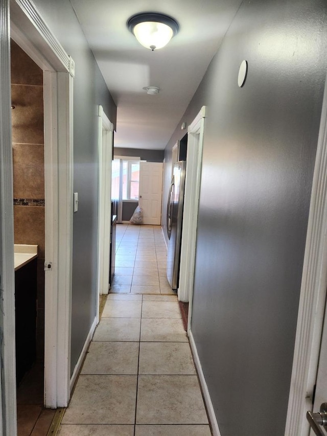 corridor featuring light tile patterned flooring