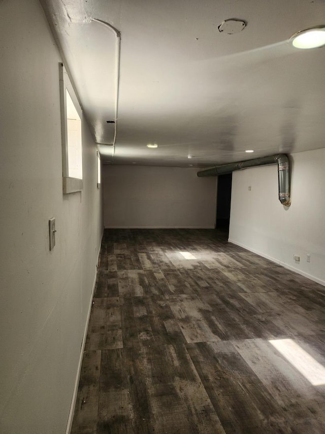 basement with dark hardwood / wood-style flooring