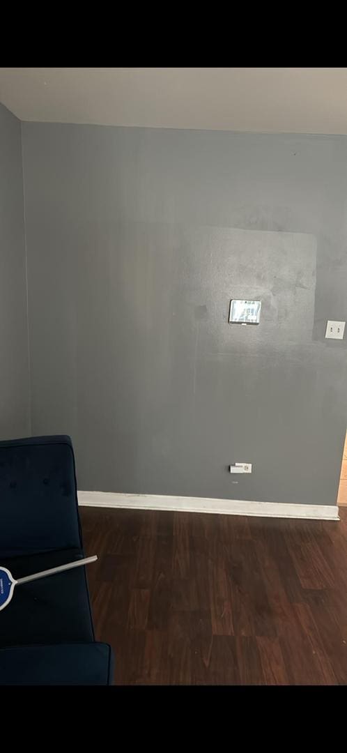 sitting room with dark wood-type flooring