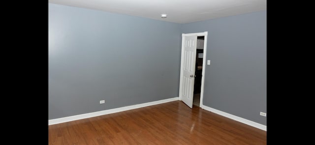 empty room with dark wood-type flooring