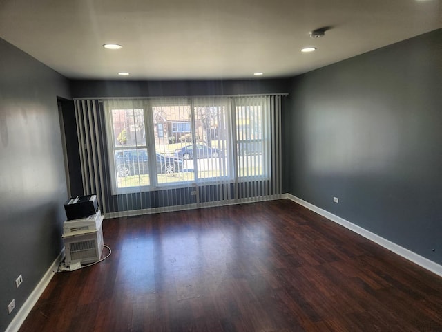 spare room with dark hardwood / wood-style floors