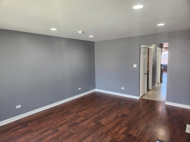 empty room with hardwood / wood-style floors