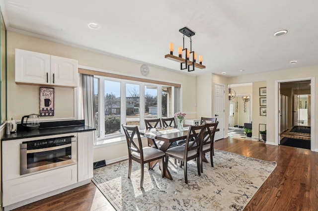 dining room featuring recessed lighting, baseboards, an inviting chandelier, and dark wood-style floors