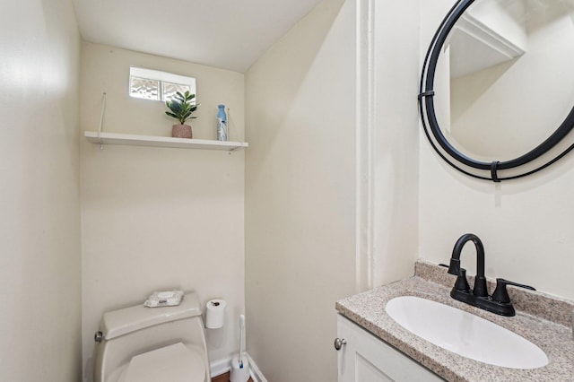 bathroom with toilet and vanity