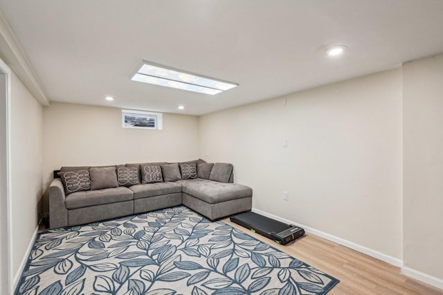 living area with recessed lighting, light wood-type flooring, and baseboards