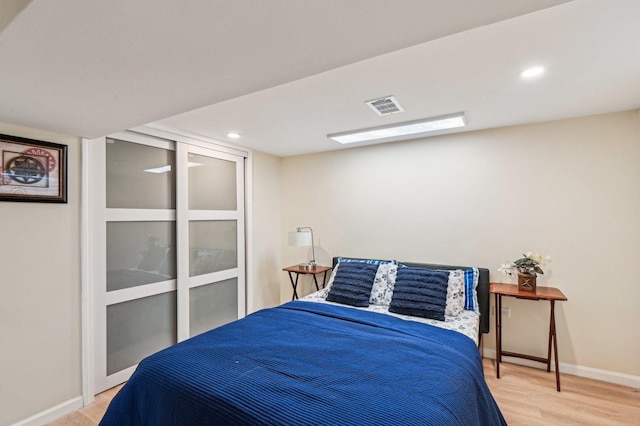 bedroom with recessed lighting, visible vents, baseboards, and light wood-style floors