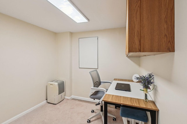 carpeted office featuring baseboards