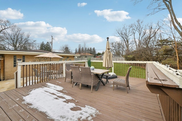 wooden deck featuring outdoor dining space and fence