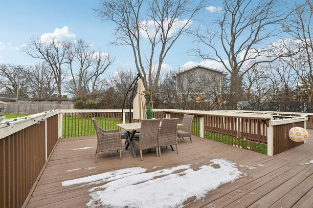 wooden terrace with a fenced backyard, a lawn, and outdoor dining space