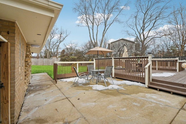 view of patio / terrace featuring a deck, outdoor dining space, and fence