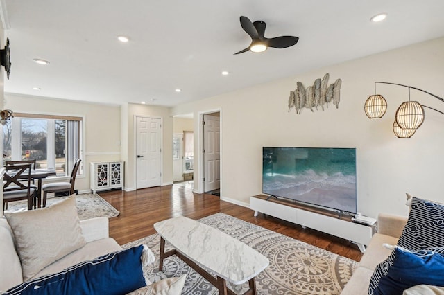 living area with recessed lighting, wood finished floors, and baseboards