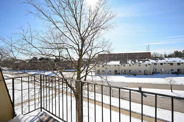 view of snow covered back of property