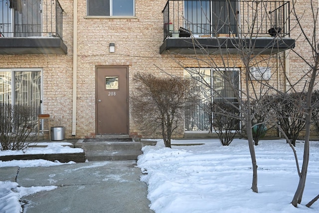 view of snow covered property entrance