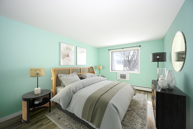 bedroom with dark wood-type flooring, a baseboard radiator, and a wall unit AC