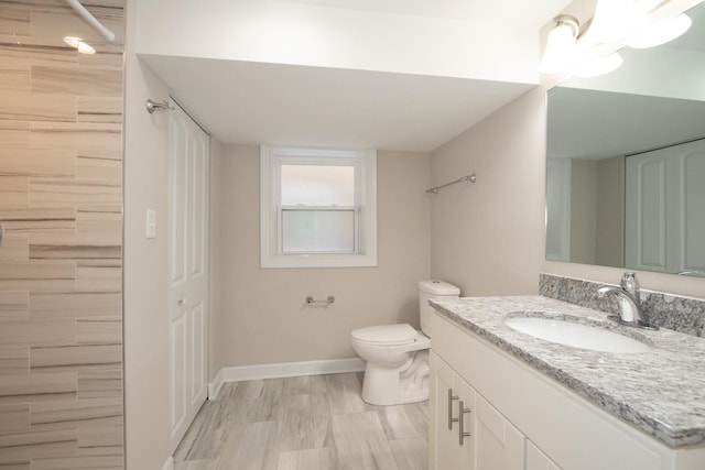 full bathroom with toilet, wood finished floors, vanity, baseboards, and a closet