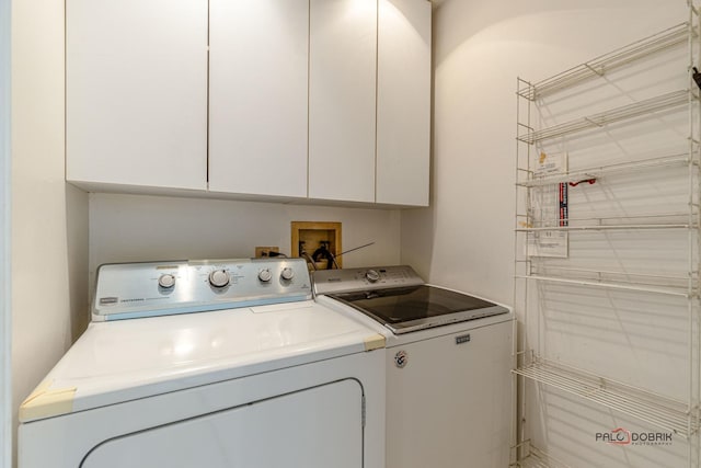 laundry area with cabinet space and washing machine and clothes dryer