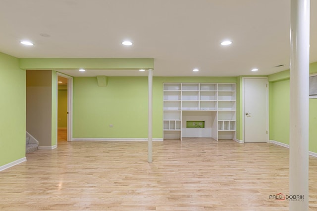 finished below grade area featuring stairs, recessed lighting, and wood finished floors