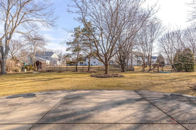 view of yard with a playground and fence