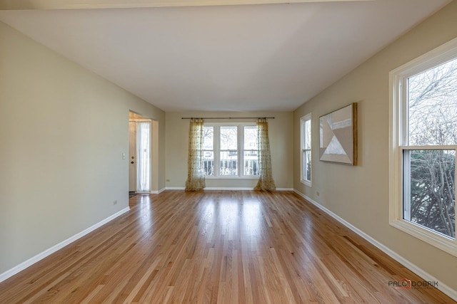 spare room with light wood-style flooring and baseboards