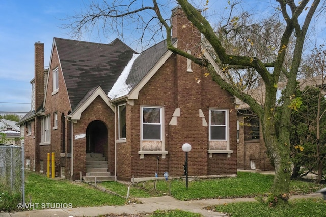 tudor house featuring a front yard