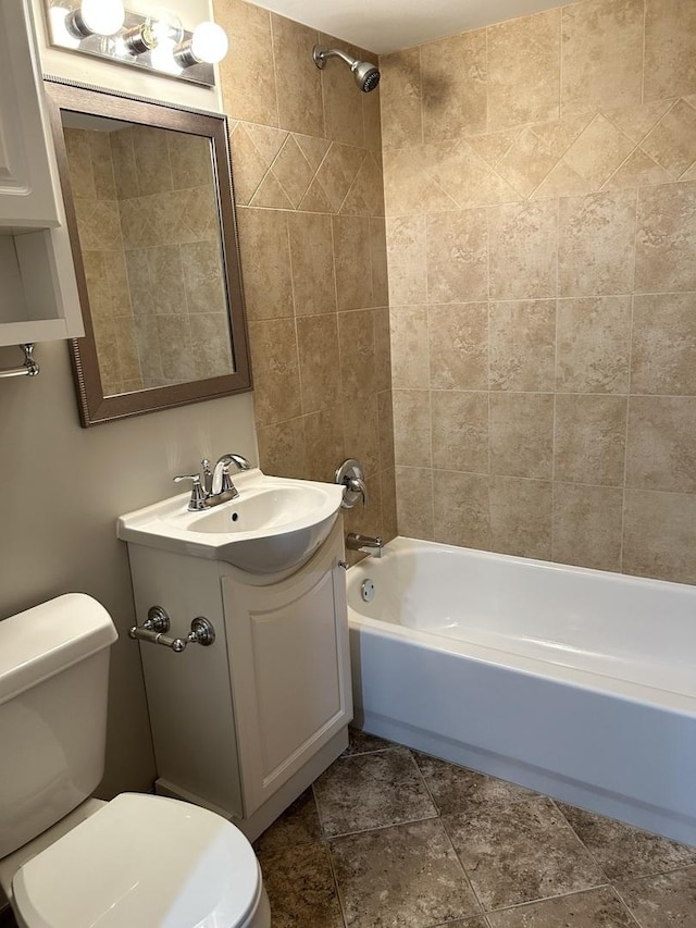 full bathroom with tiled shower / bath combo, toilet, and vanity