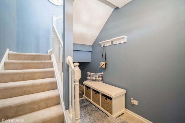 stairs with lofted ceiling and baseboards