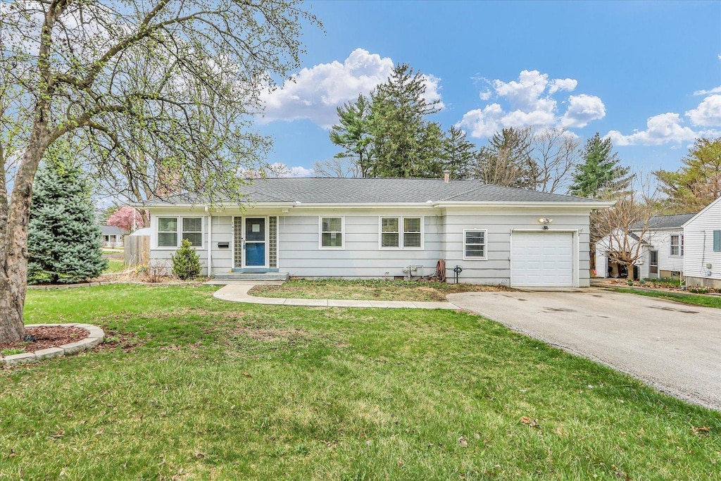 1401 W Green St, Champaign, IL 61821 - ranch-style home featuring a front yard, an attached garage, and aphalt driveway