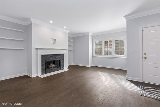 unfurnished living room featuring crown molding, baseboards, built in features, a fireplace with flush hearth, and dark wood-style flooring