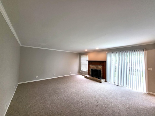 unfurnished living room featuring a brick fireplace, carpet floors, and ornamental molding