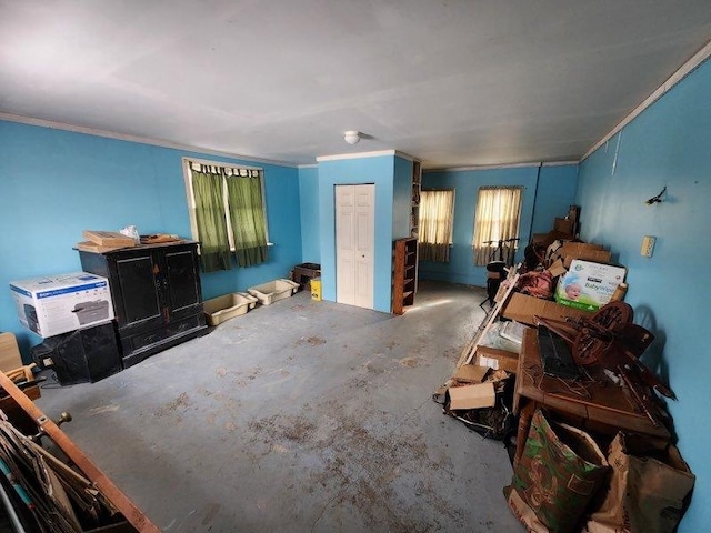 bedroom featuring unfinished concrete flooring and crown molding