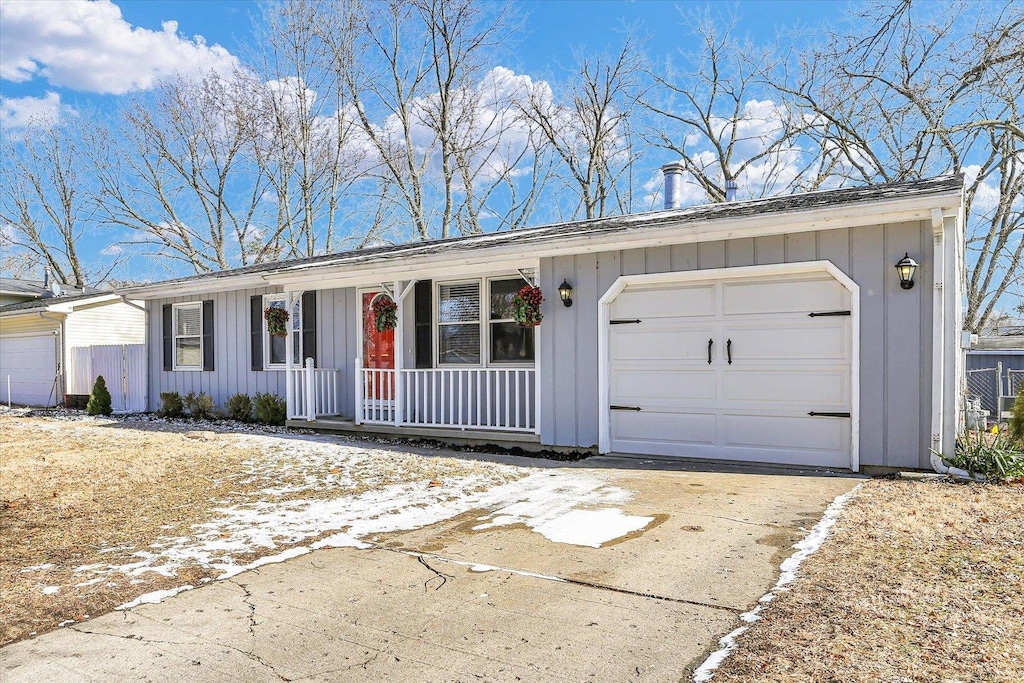 ranch-style home featuring board and batten siding, concrete driveway, and a garage