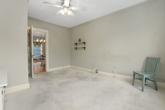 carpeted empty room featuring ornamental molding, ceiling fan, and baseboards