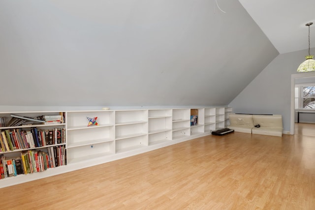 bonus room featuring lofted ceiling and light wood-style floors