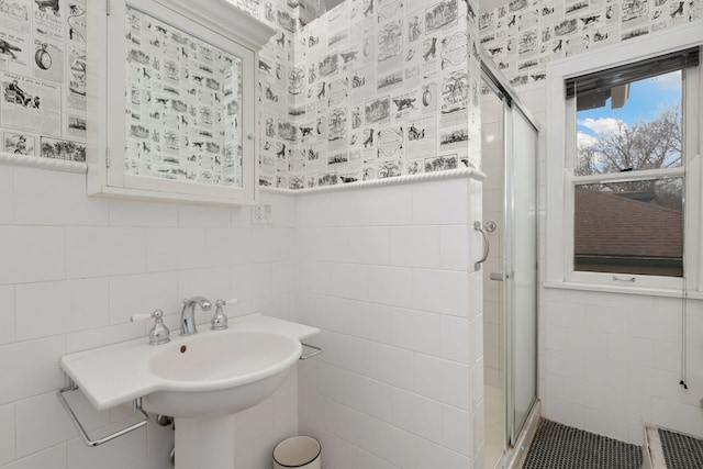 bathroom featuring a stall shower and tile walls