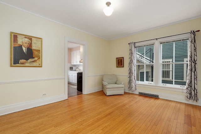 unfurnished room featuring crown molding, baseboards, visible vents, and light wood-style floors