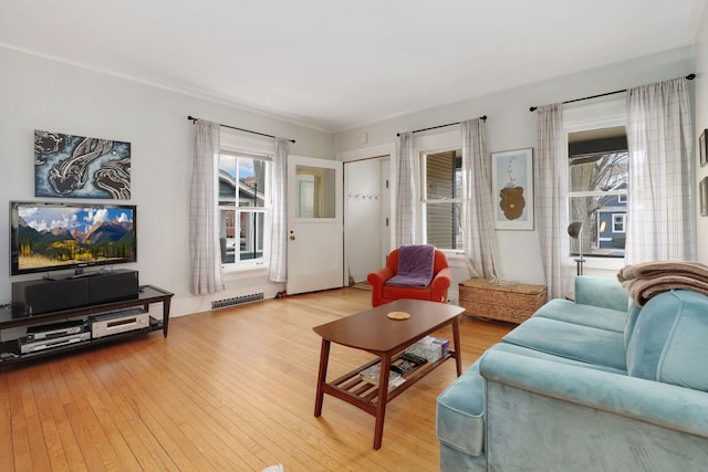 living room with hardwood / wood-style floors and visible vents