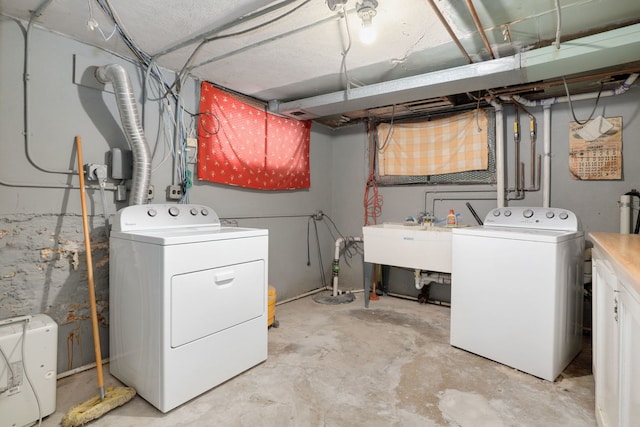 laundry area featuring washer and dryer, laundry area, and a sink