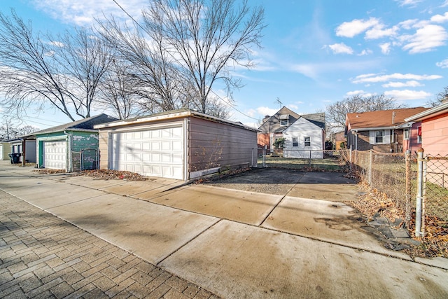 detached garage featuring fence