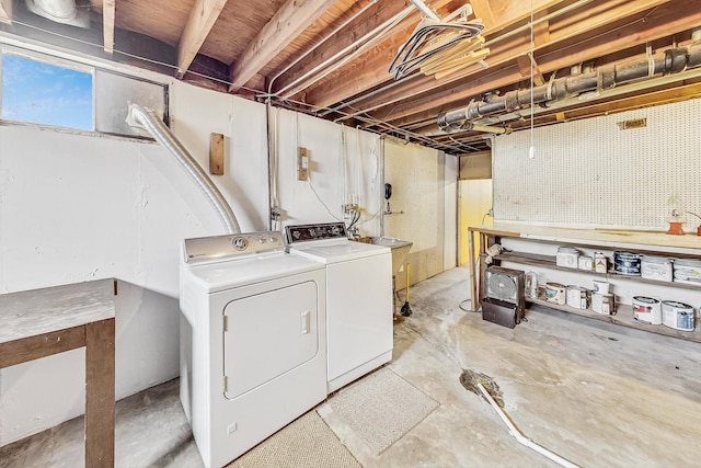 clothes washing area featuring laundry area, separate washer and dryer, and a workshop area