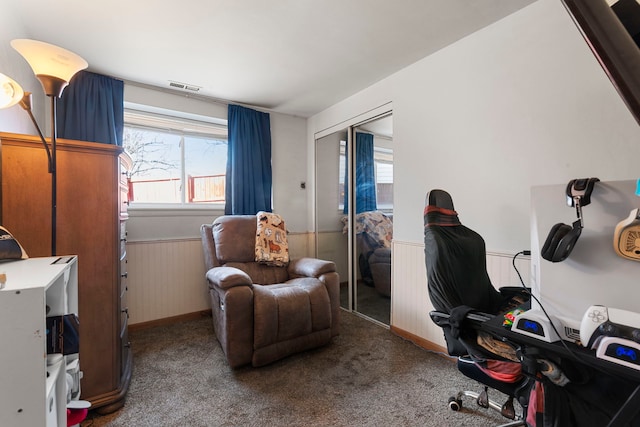 office area with carpet flooring, a healthy amount of sunlight, and wainscoting