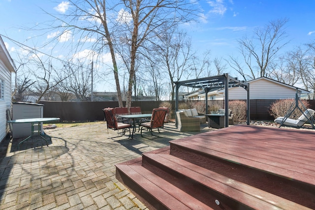 deck featuring outdoor dining space, a fenced backyard, a pergola, outdoor lounge area, and a patio area