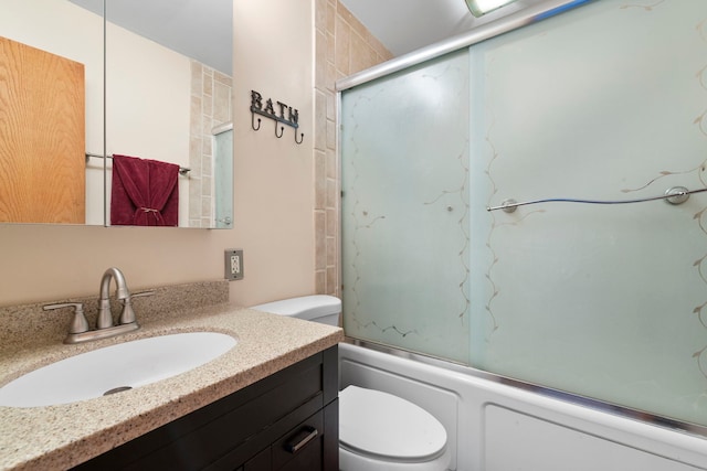 full bath with vanity, toilet, and shower / bath combination with glass door