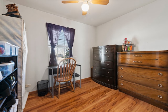 office featuring baseboards, light wood finished floors, and ceiling fan