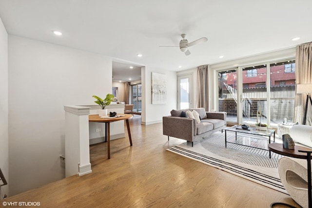 living room with plenty of natural light, wood finished floors, and recessed lighting