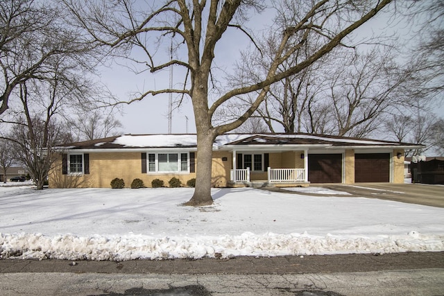 view of front of property with a porch, brick siding, and an attached garage