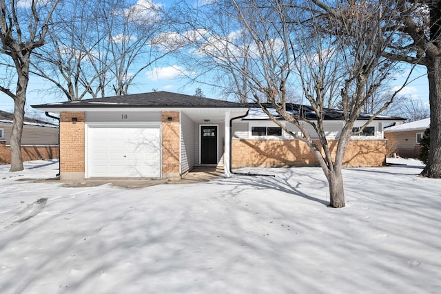 ranch-style house featuring a garage and brick siding