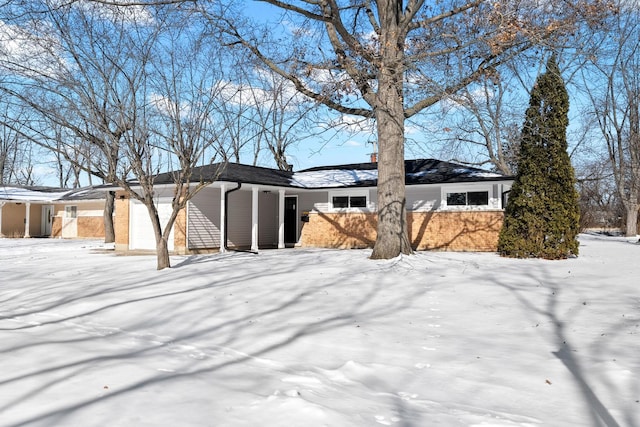 exterior space with a garage and brick siding