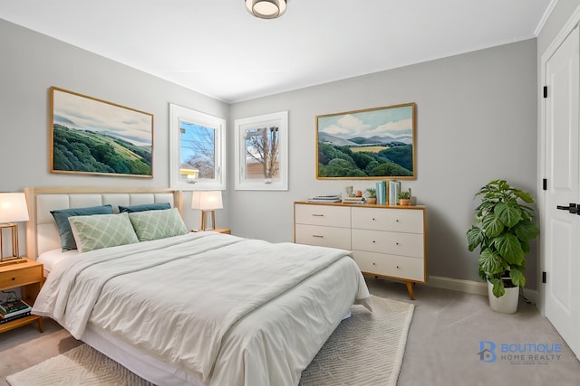 bedroom with light carpet and baseboards