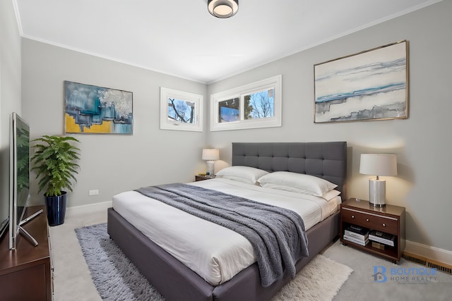 bedroom with light carpet, crown molding, visible vents, and baseboards